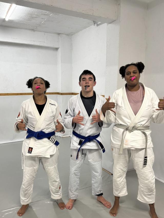 Gonçalo and two training partners after class, mouthguards in